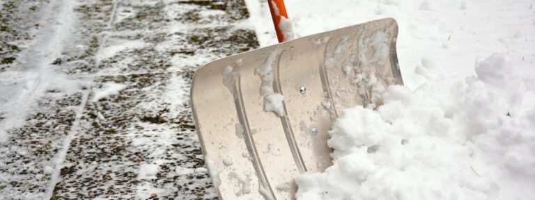 Schneeschieber im Schnee beim Schneedienst